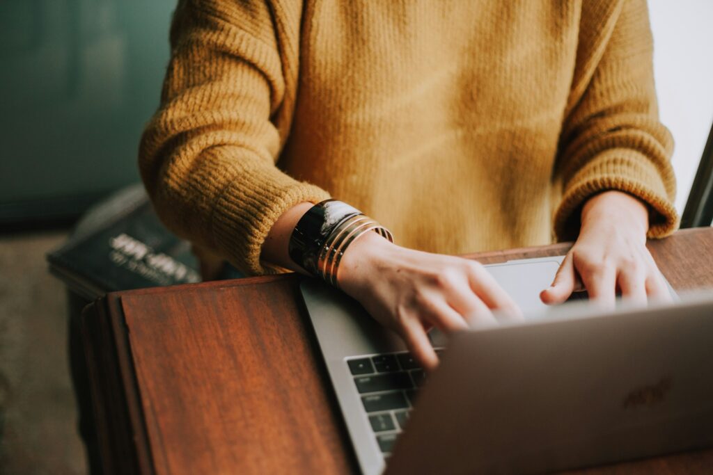 mujer escribiendo portatil